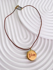 Christian Dior bottle cap necklace, vintage 1990s gold logo pendant designed by John Galliano, rare Dior jewelry
