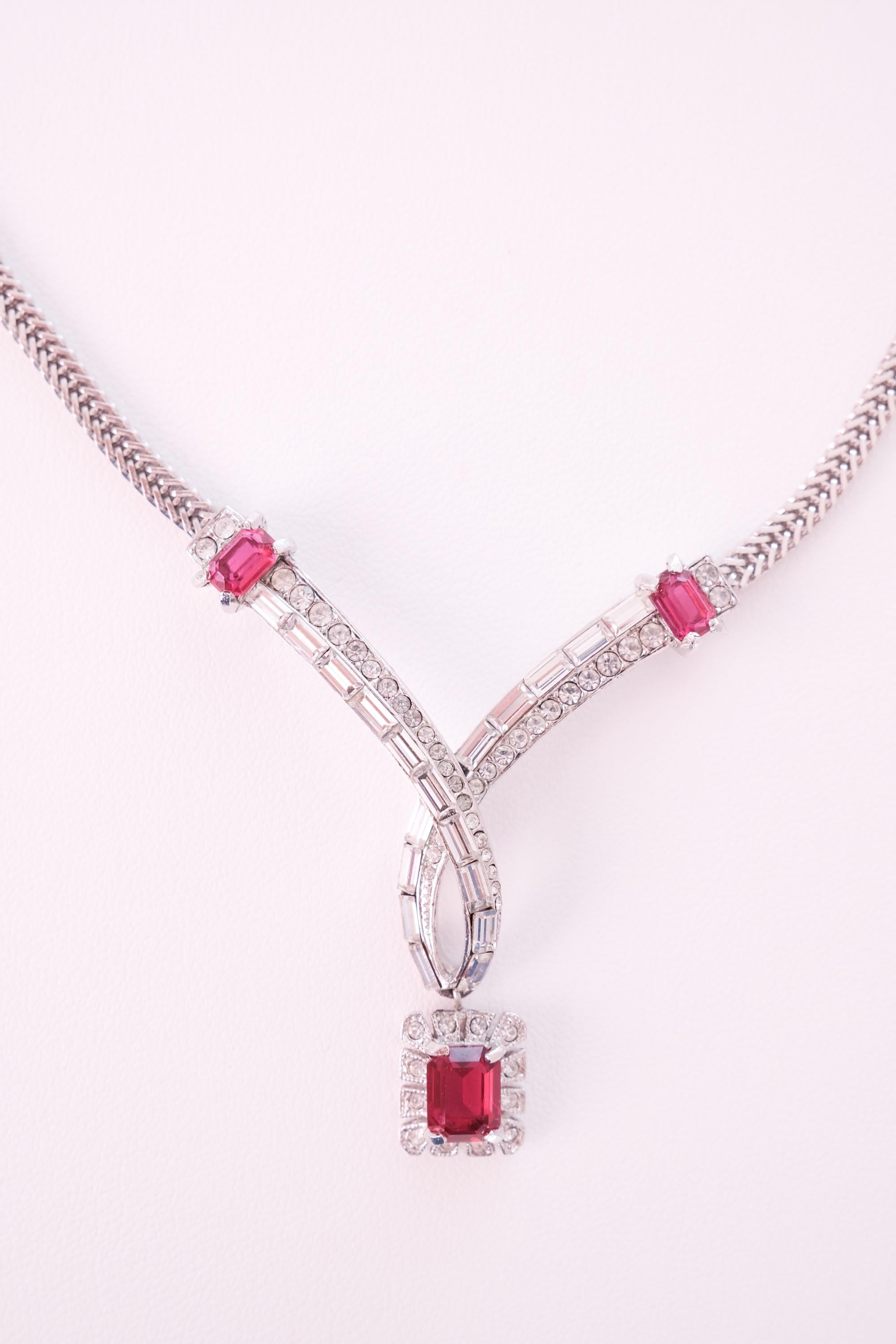 Close up of Attwood and Sawyer vintage pendant with ruby red crystals and clear rhinestones