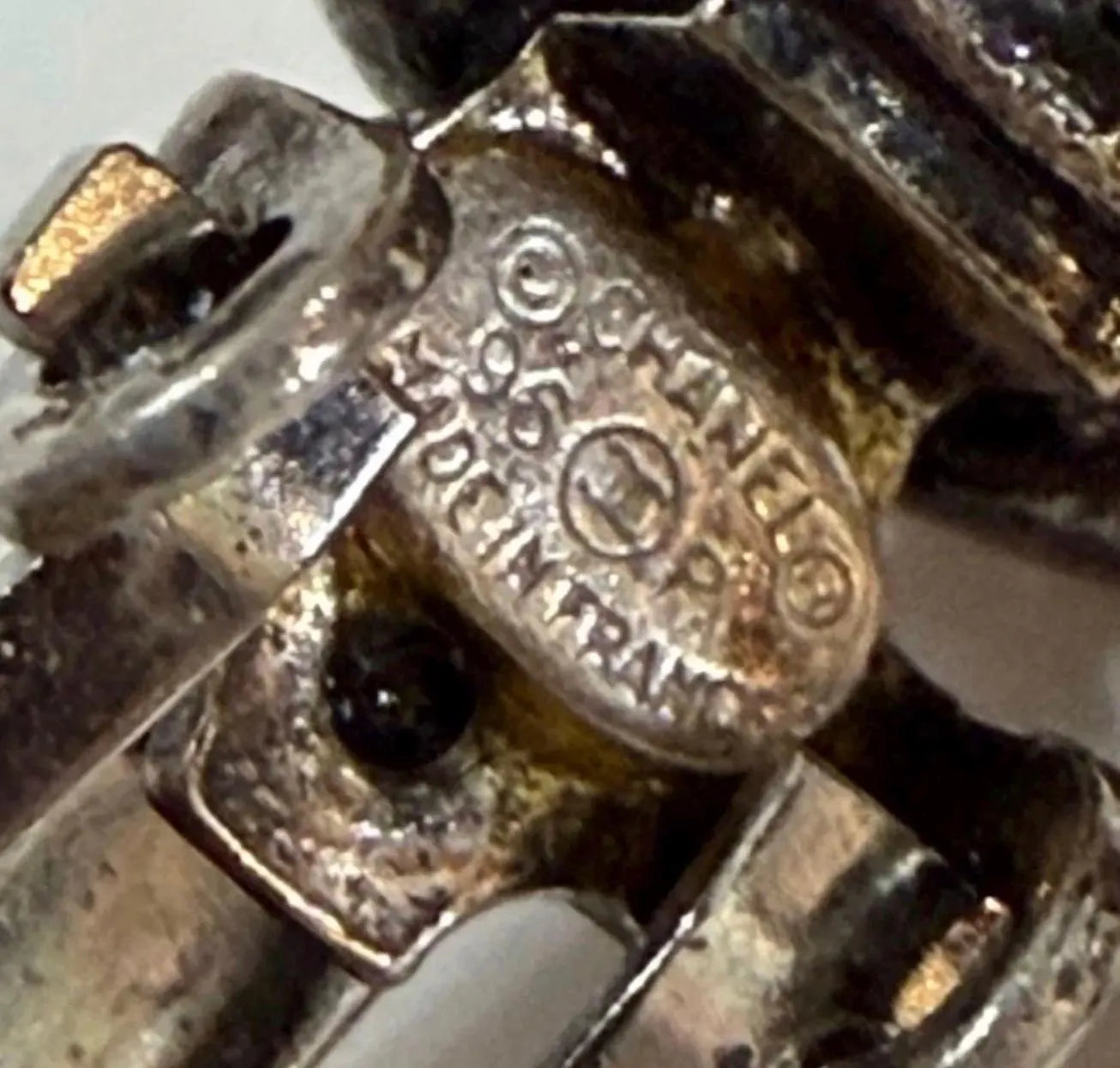 Close-up of CHANEL 96P Made in France signature marking on vintage silver-tone crystal earrings
