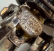 Close-up of CHANEL 96P Made in France signature marking on vintage silver-tone crystal earrings