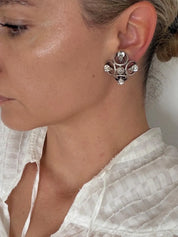 Front view of CHANEL 1996P silver-tone statement earrings with four faceted clear teardrop crystals on each earring