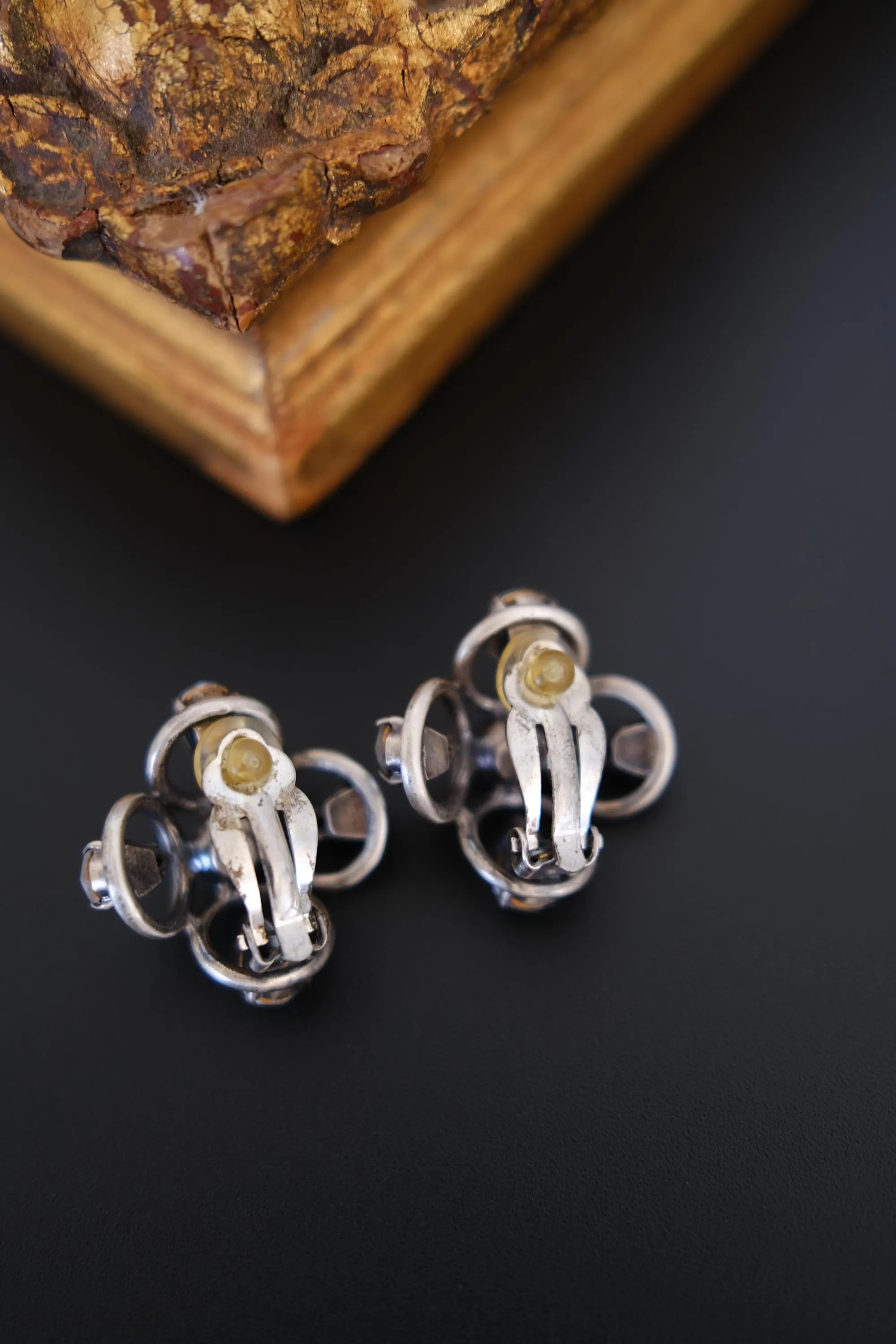 Reverse view of vintage CHANEL 1996P clip-on earrings showing metal construction and original clip fittings