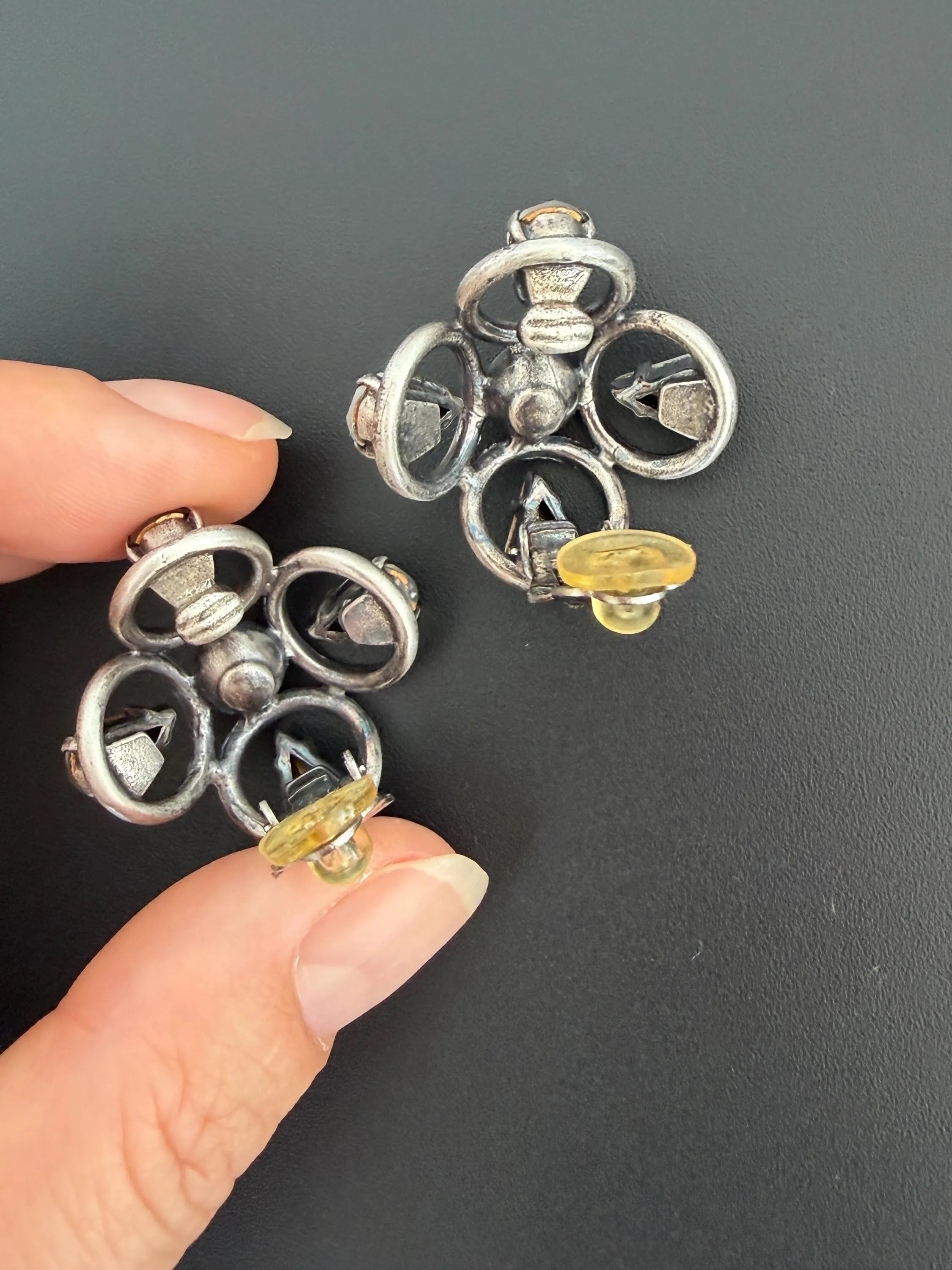 Reverse view of vintage CHANEL 1996P clip-on earrings showing metal construction and original clip fittings