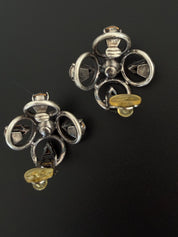 Reverse view of vintage CHANEL 1996P clip-on earrings showing metal construction and original clip fittings