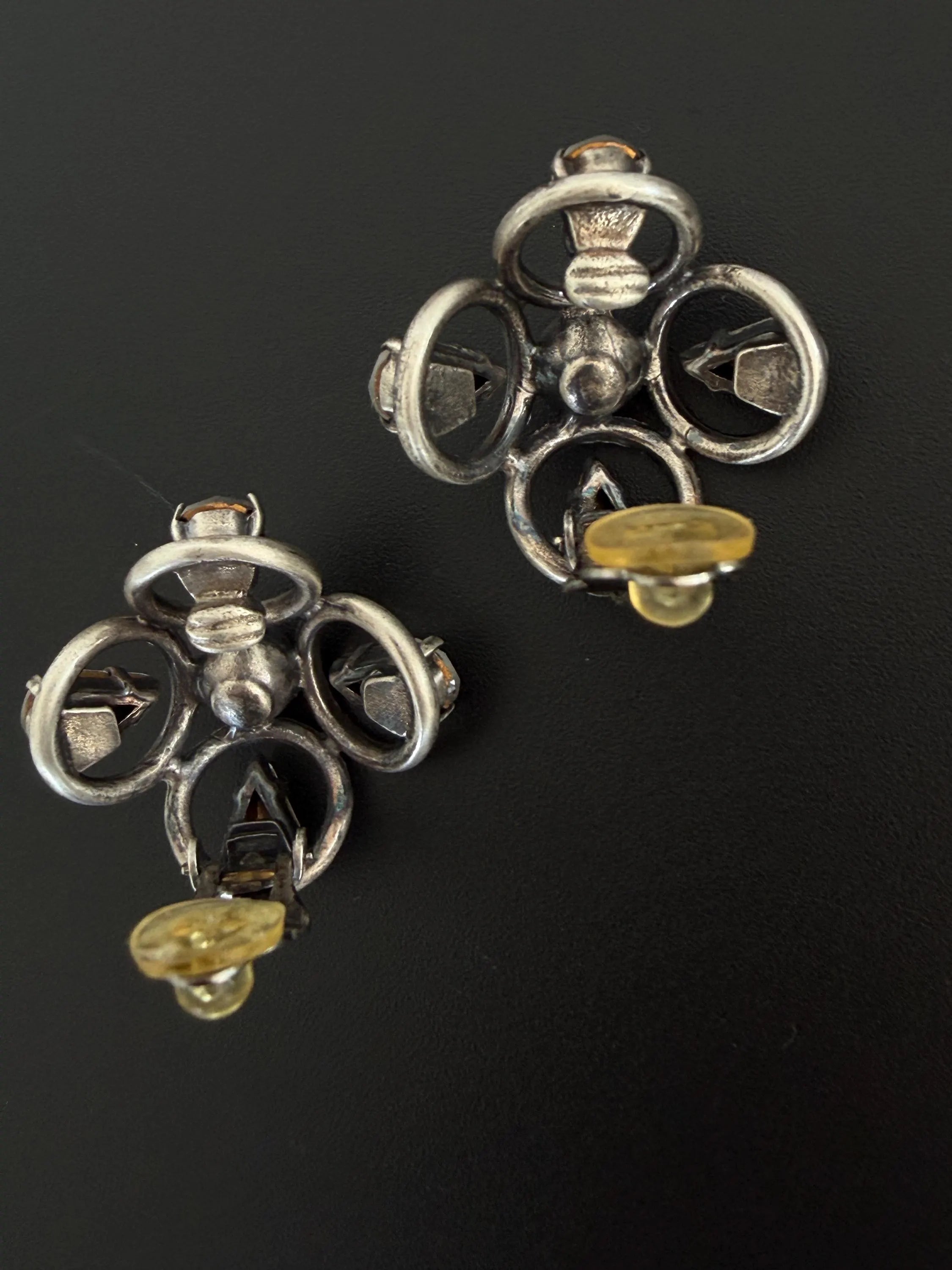 Reverse view of vintage CHANEL 1996P clip-on earrings showing metal construction and original clip fittings