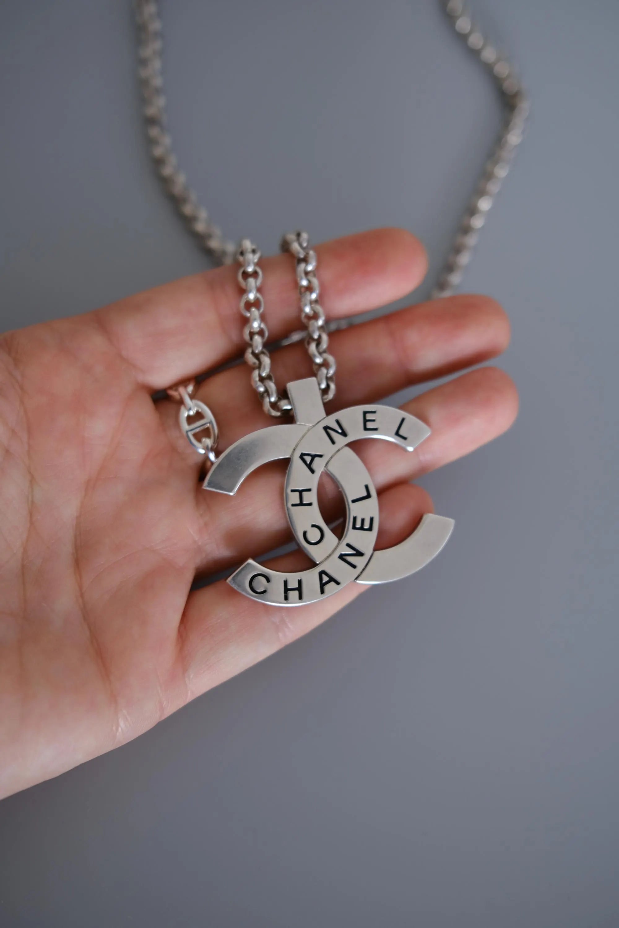 CHANEL 1998 vintage silver-tone interlocking CC logo pendant with CHANEL lettering