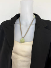 CHANEL vintage ivory camellia pendant necklace styled with an elegant dress
