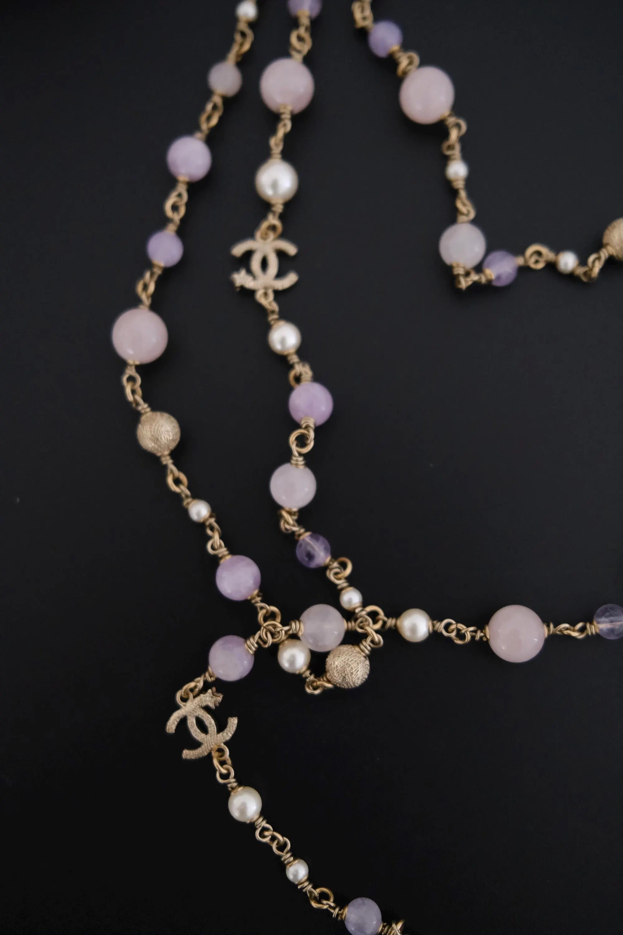 Detailed view of white faux pearls and lavender glass beads on vintage CHANEL sautoir necklace