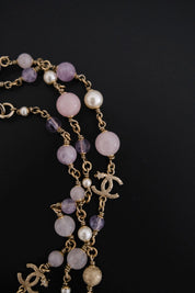 Close-up of lavender purple Gripoix glass beads on vintage CHANEL long necklace
