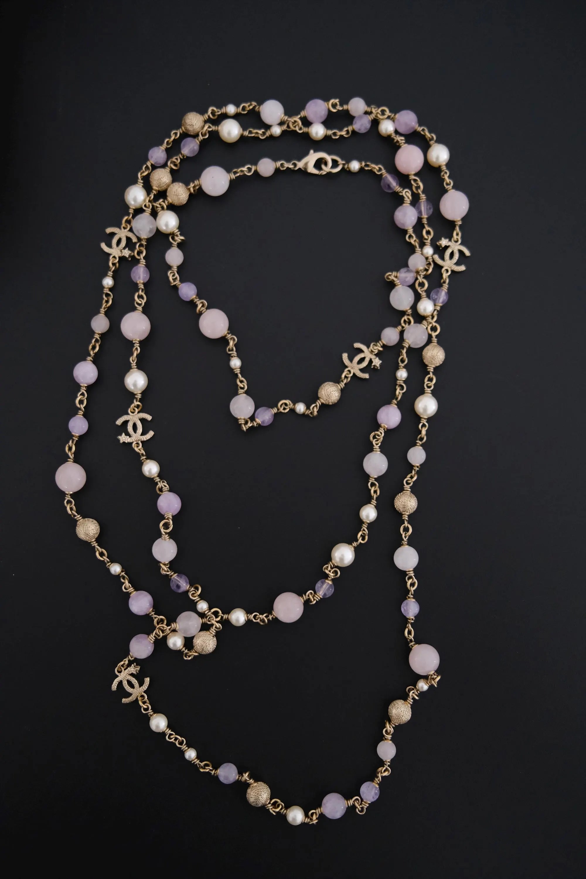 Full view of vintage CHANEL 168 cm gold-tone sautoir necklace with lavender beads, faux pearls and CC logo charms