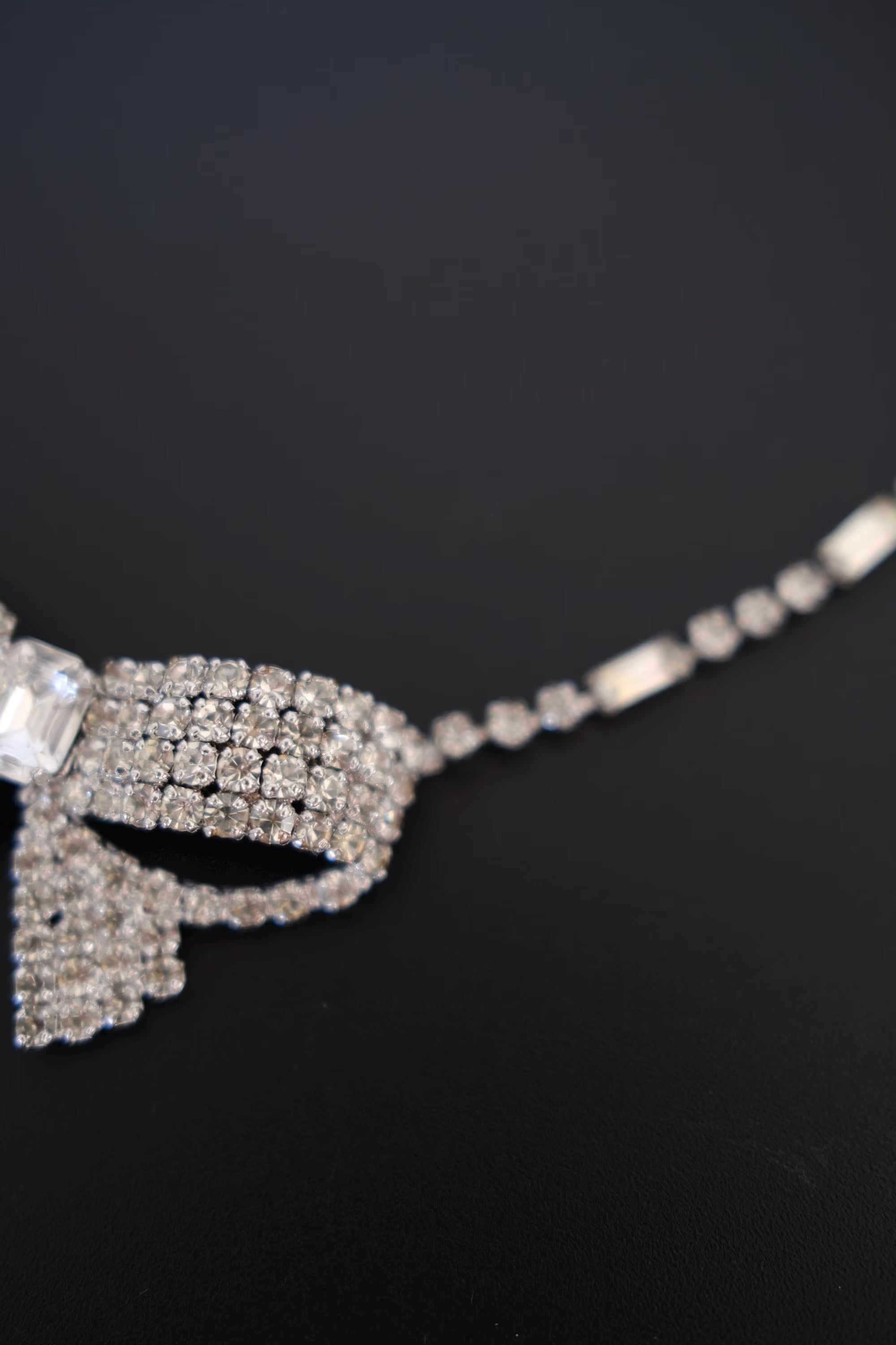 Angled close-up of dimensional layered crystal bow construction on vintage Christian Dior statement necklace
