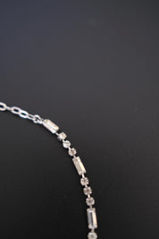 Detailed view of alternating round and rectangular crystal-set links on vintage Christian Dior silver-tone necklace