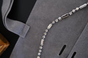 Detailed view of alternating round and rectangular crystal-set links on vintage Christian Dior silver-tone necklace