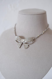Condition close-up of vintage Christian Dior crystal bow necklace showing slight age-related dullness on some clear crystals