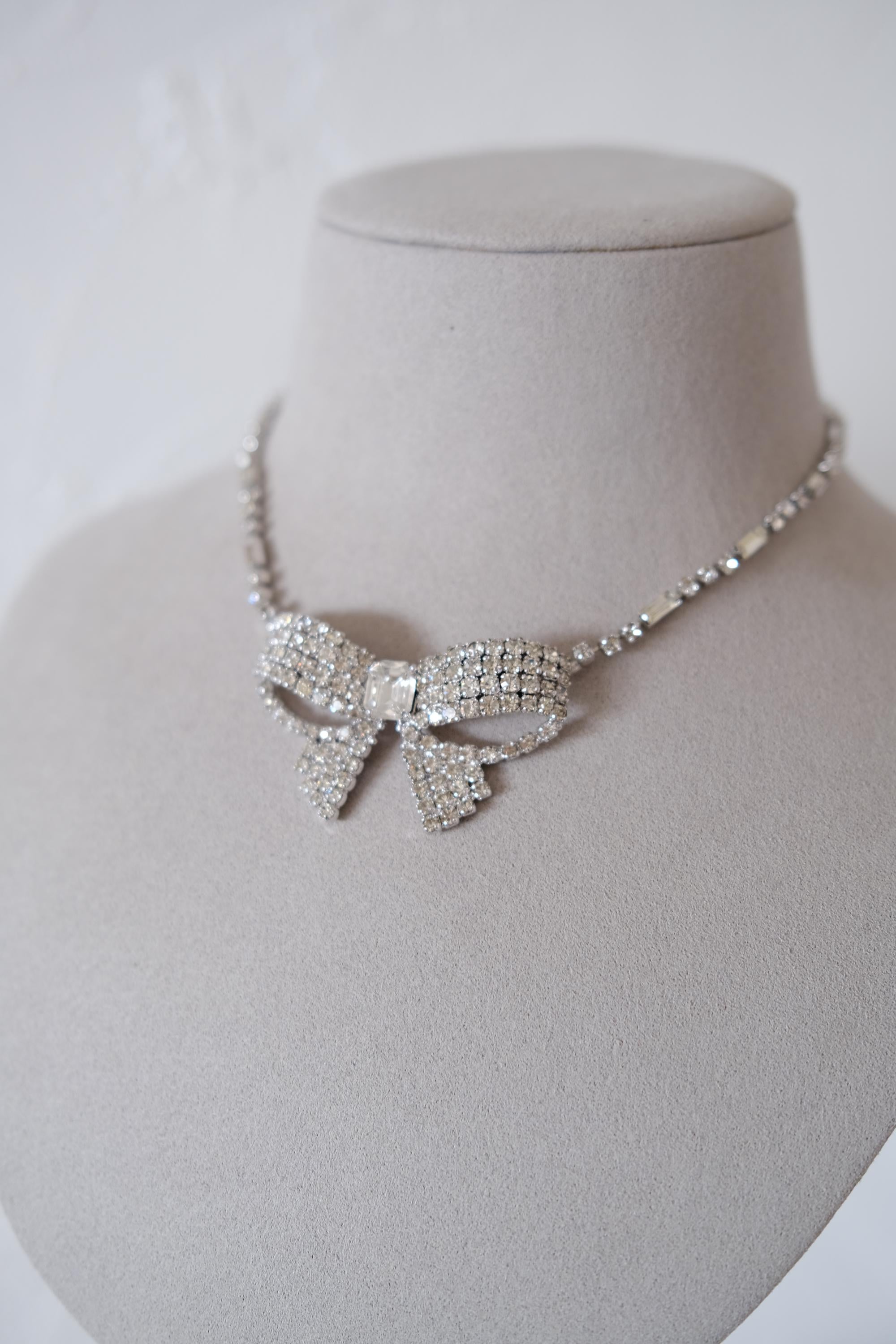 Condition close-up of vintage Christian Dior crystal bow necklace showing slight age-related dullness on some clear crystals