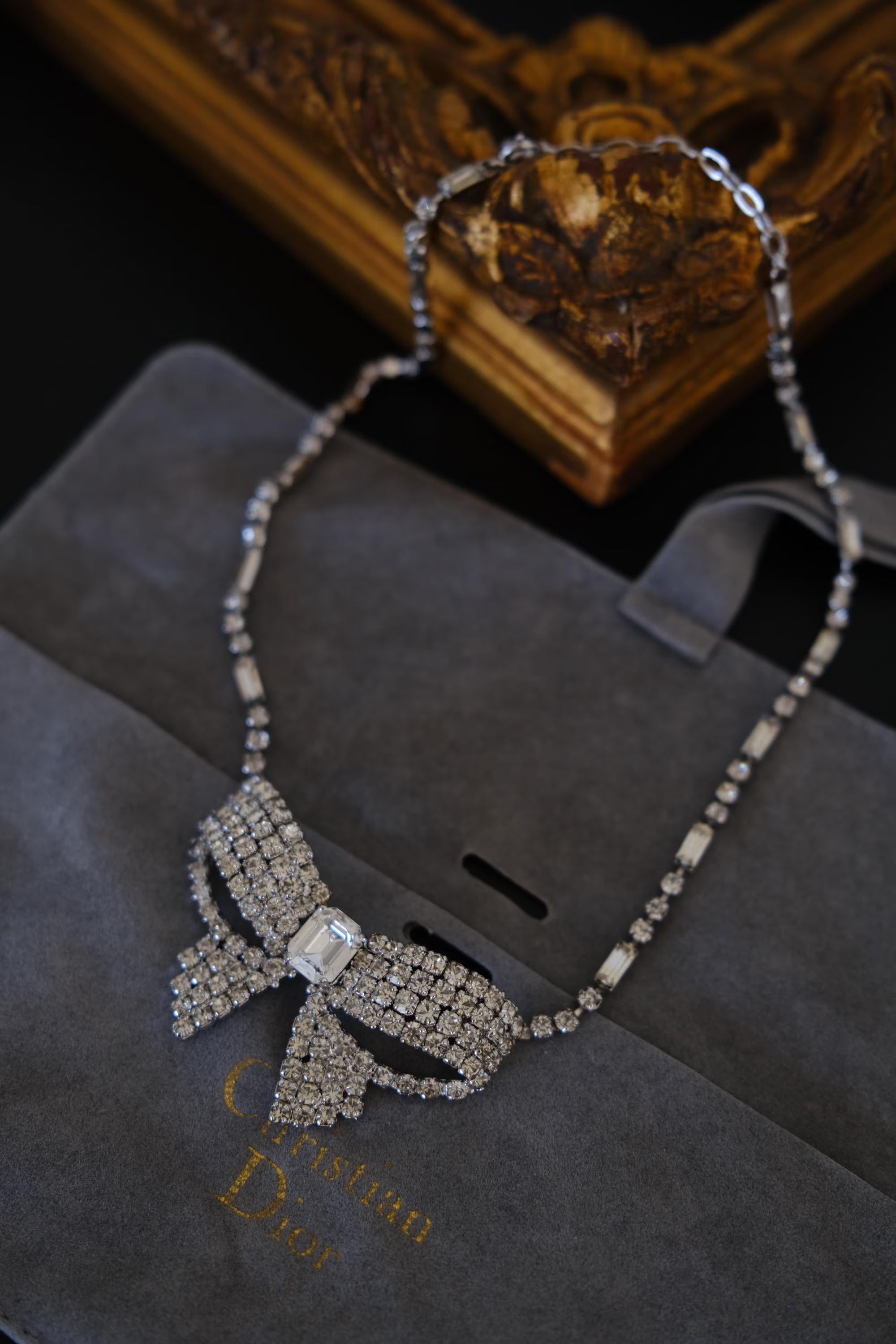 Vintage Christian Dior crystal bow necklace displayed with Christian Dior branded packaging