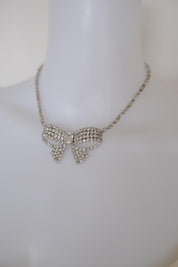 Vintage Christian Dior crystal ribbon bow choker worn at the neckline as an elegant statement necklace