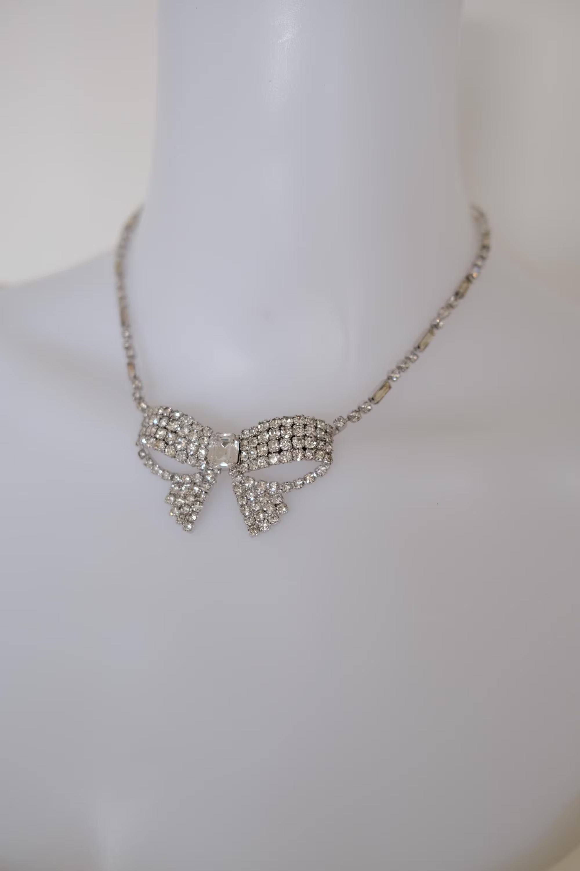 Vintage Christian Dior crystal ribbon bow choker worn at the neckline as an elegant statement necklace