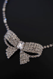 Macro detail of clear round and rectangular crystals on vintage Christian Dior Germany bow choker necklace