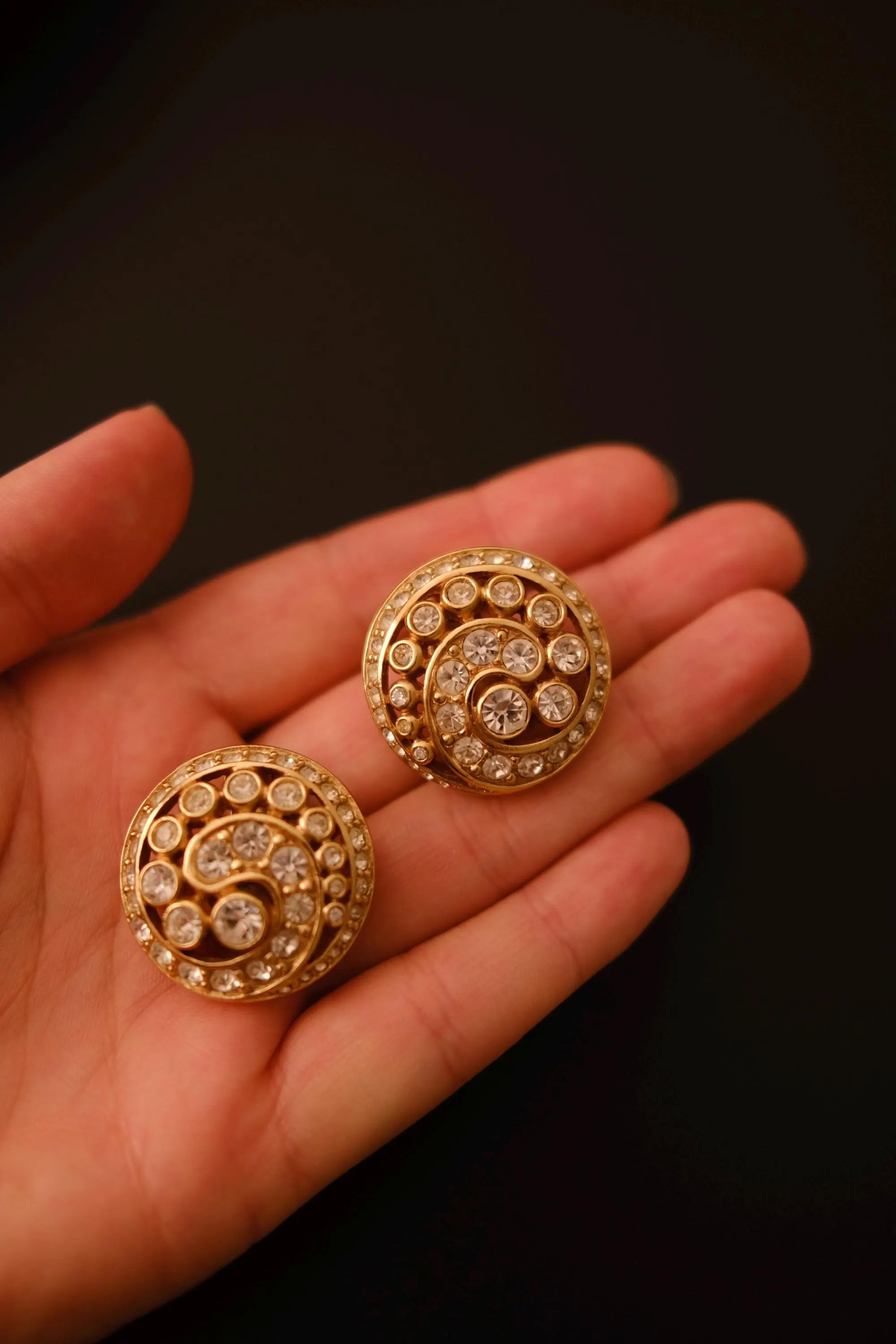 Vintage Christian Dior round crystal swirl clip-on earrings measuring approximately 3 cm in diameter
