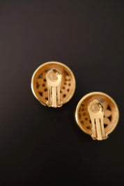 Close-up of clip-on fastening mechanism on vintage Christian Dior gold-tone crystal spiral earrings