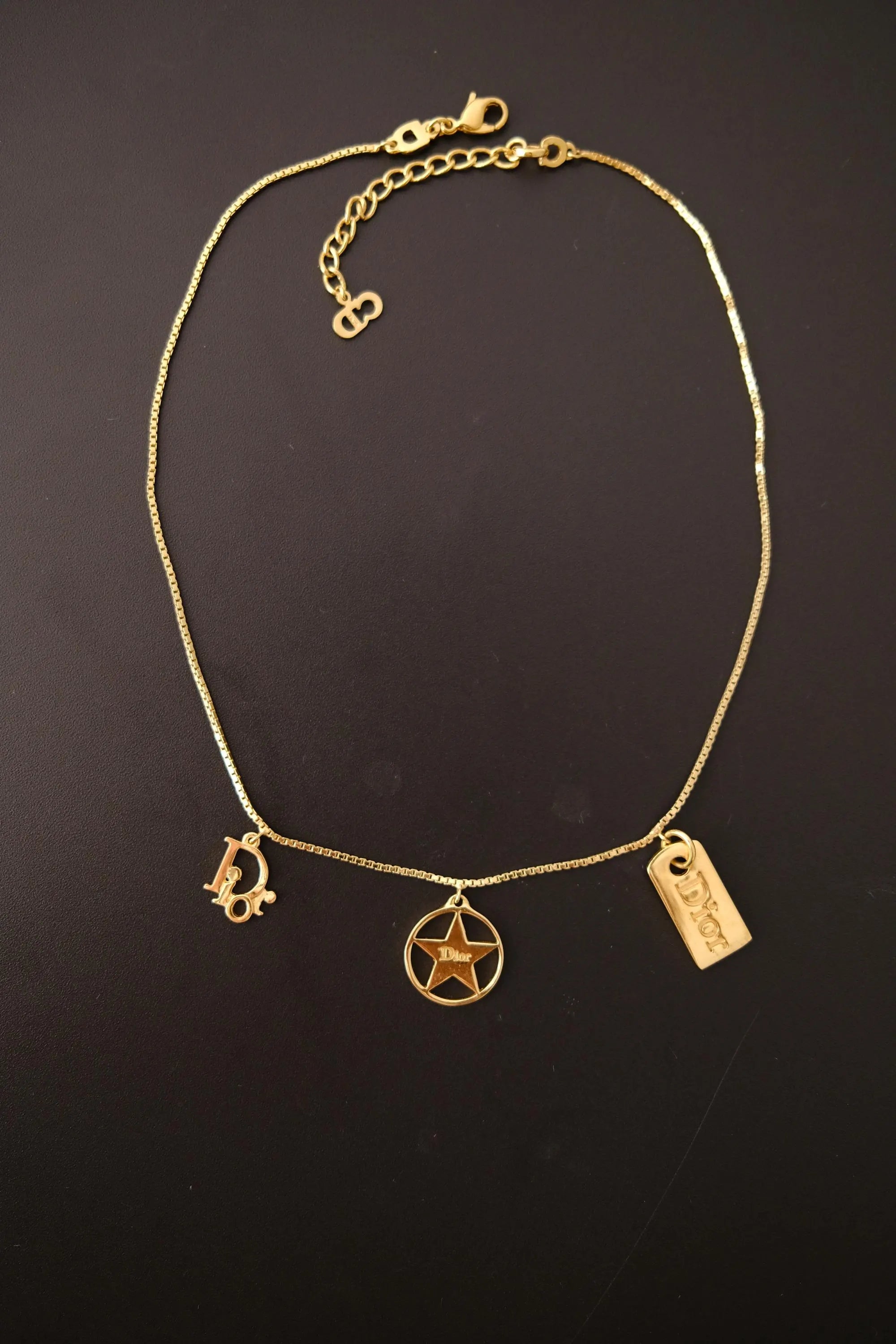 Vintage Christian Dior gold three charm necklace measuring approximately 43 cm long with adjustable extender