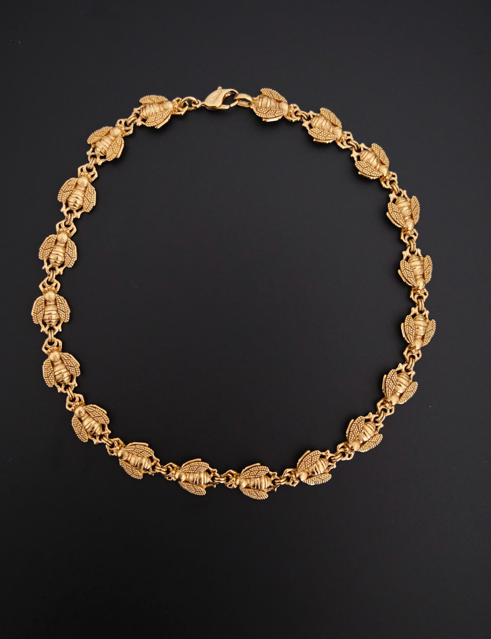 Vintage Christian Dior gold-tone necklace featuring 19 sculptural bee motifs, signed Dior Germany