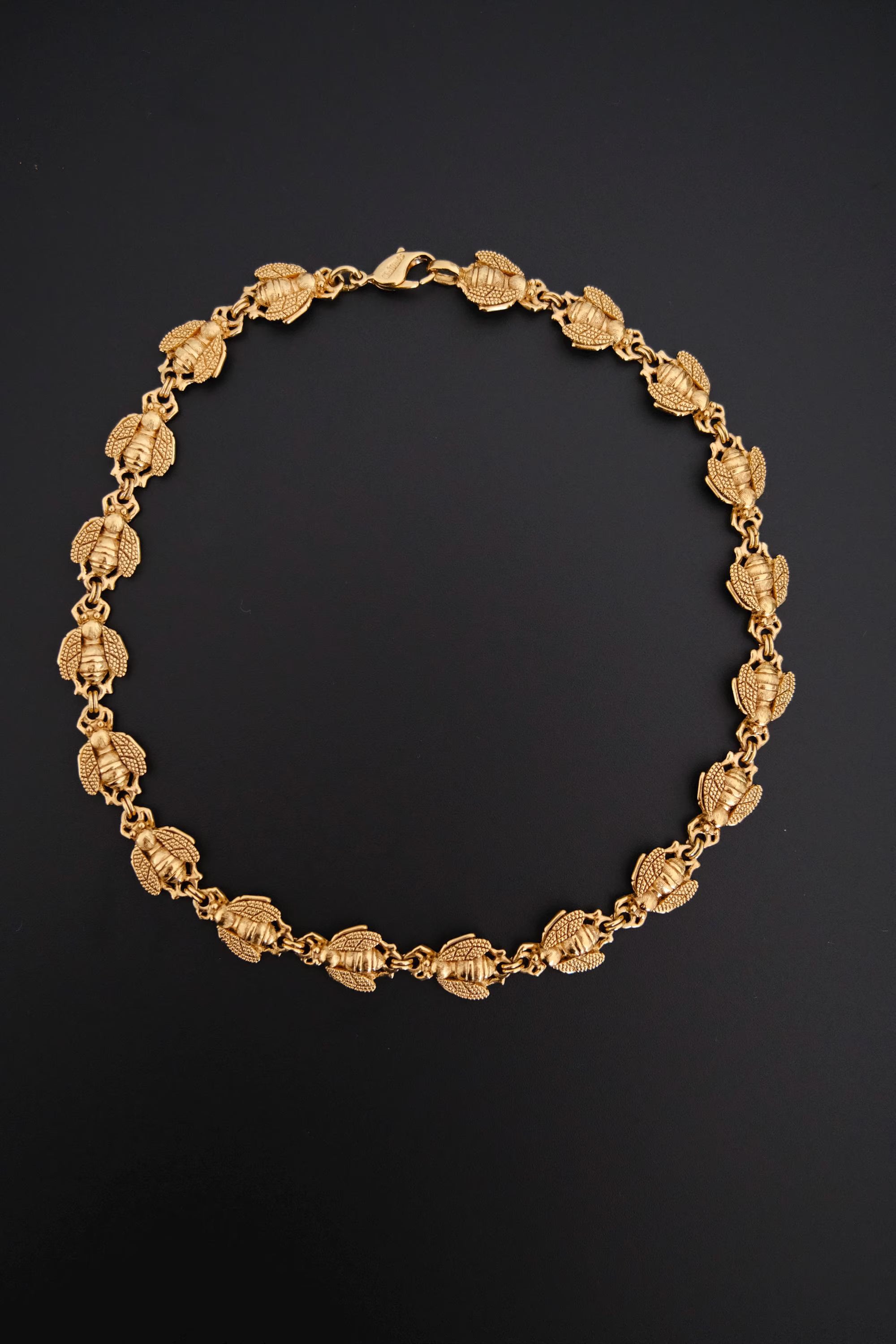 Vintage Christian Dior gold-tone necklace featuring 19 sculptural bee motifs, signed Dior Germany