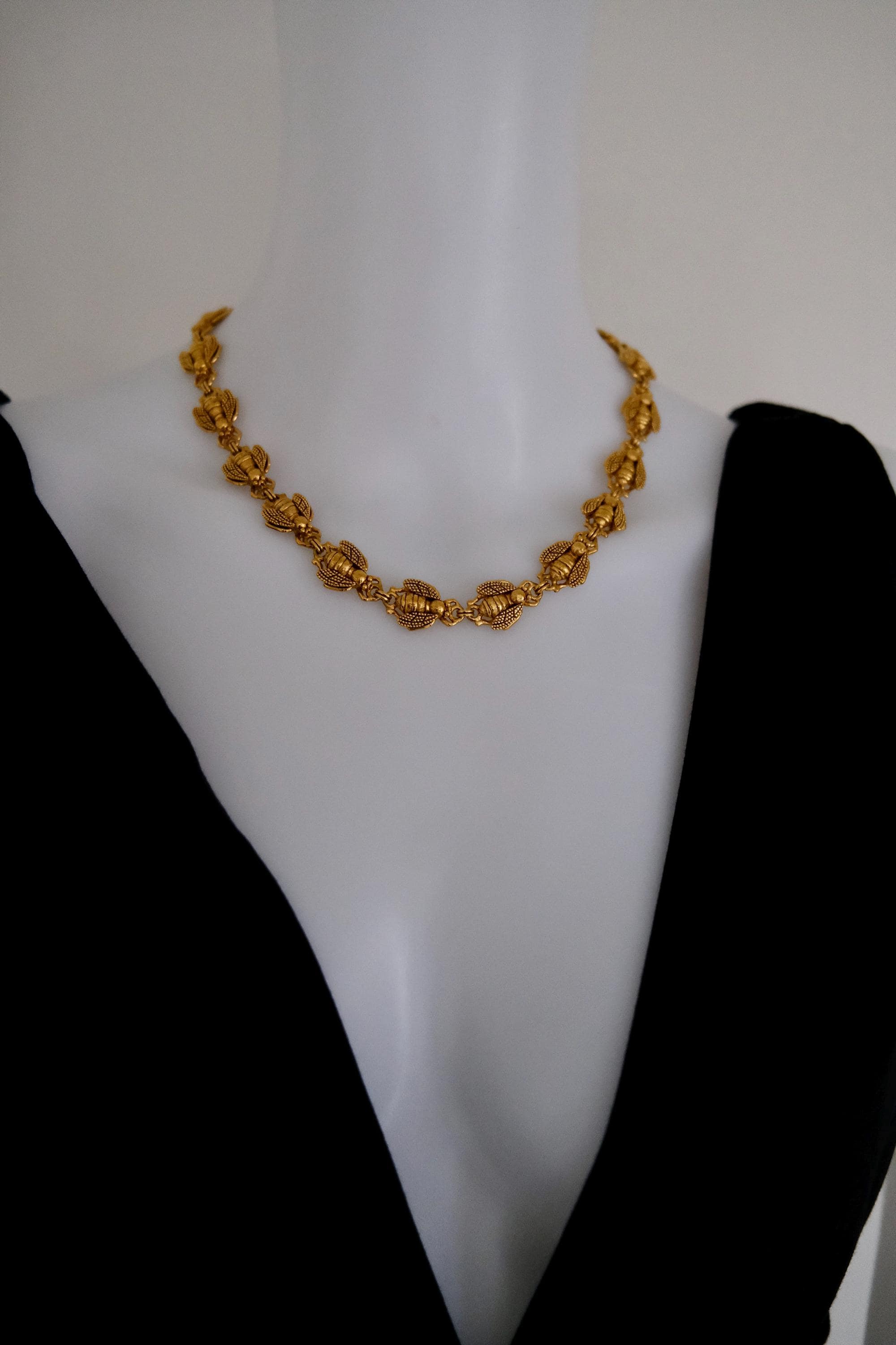 Vintage Christian Dior gold-tone necklace featuring 19 sculptural bee motifs, signed Dior Germany