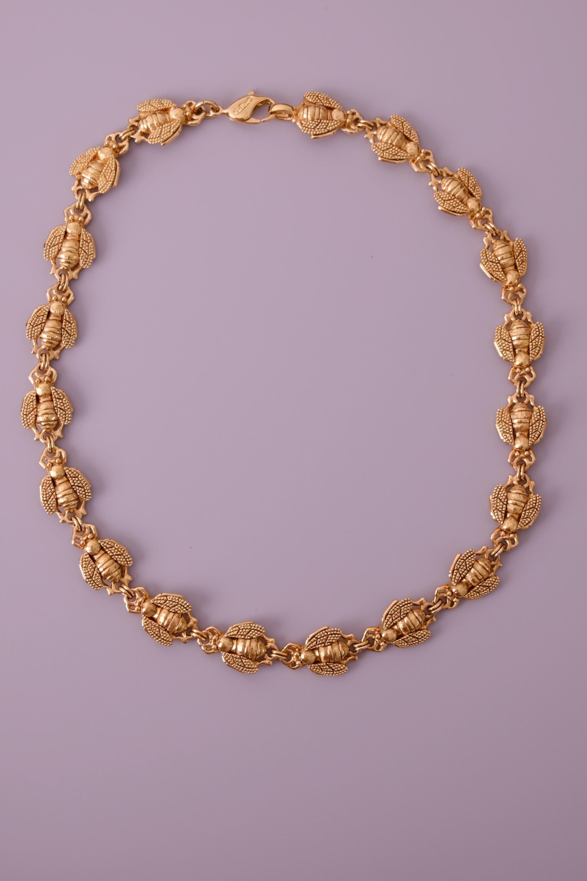 Vintage Christian Dior gold-tone necklace featuring 19 sculptural bee motifs, signed Dior Germany