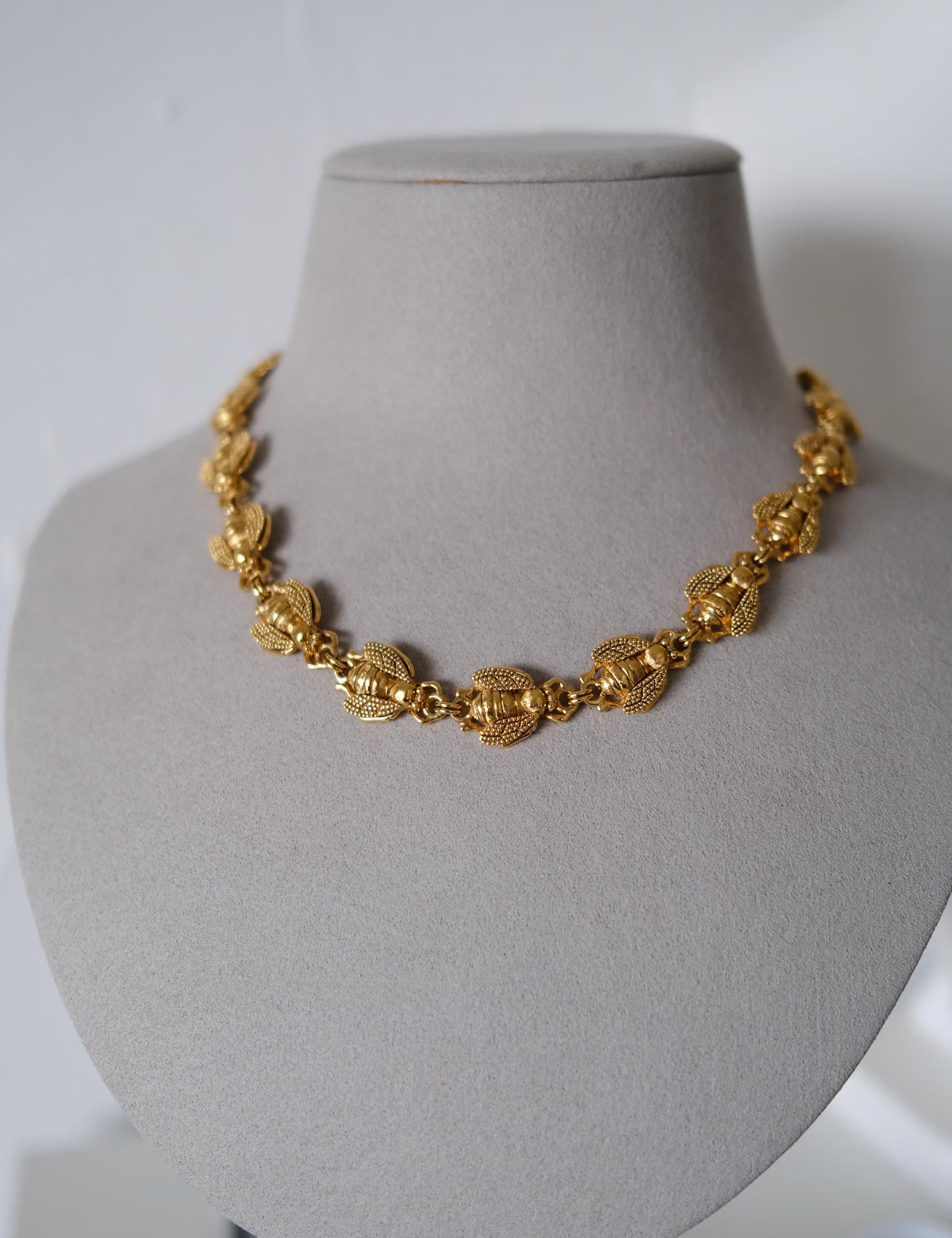 Vintage Christian Dior gold-tone necklace featuring 19 sculptural bee motifs, signed Dior Germany