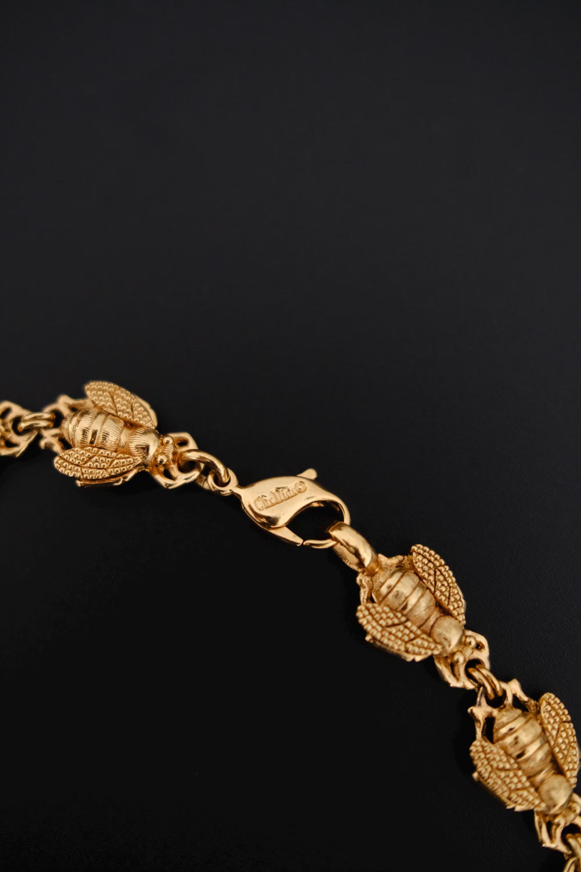 Vintage Christian Dior gold-tone necklace featuring 19 sculptural bee motifs, signed Dior Germany