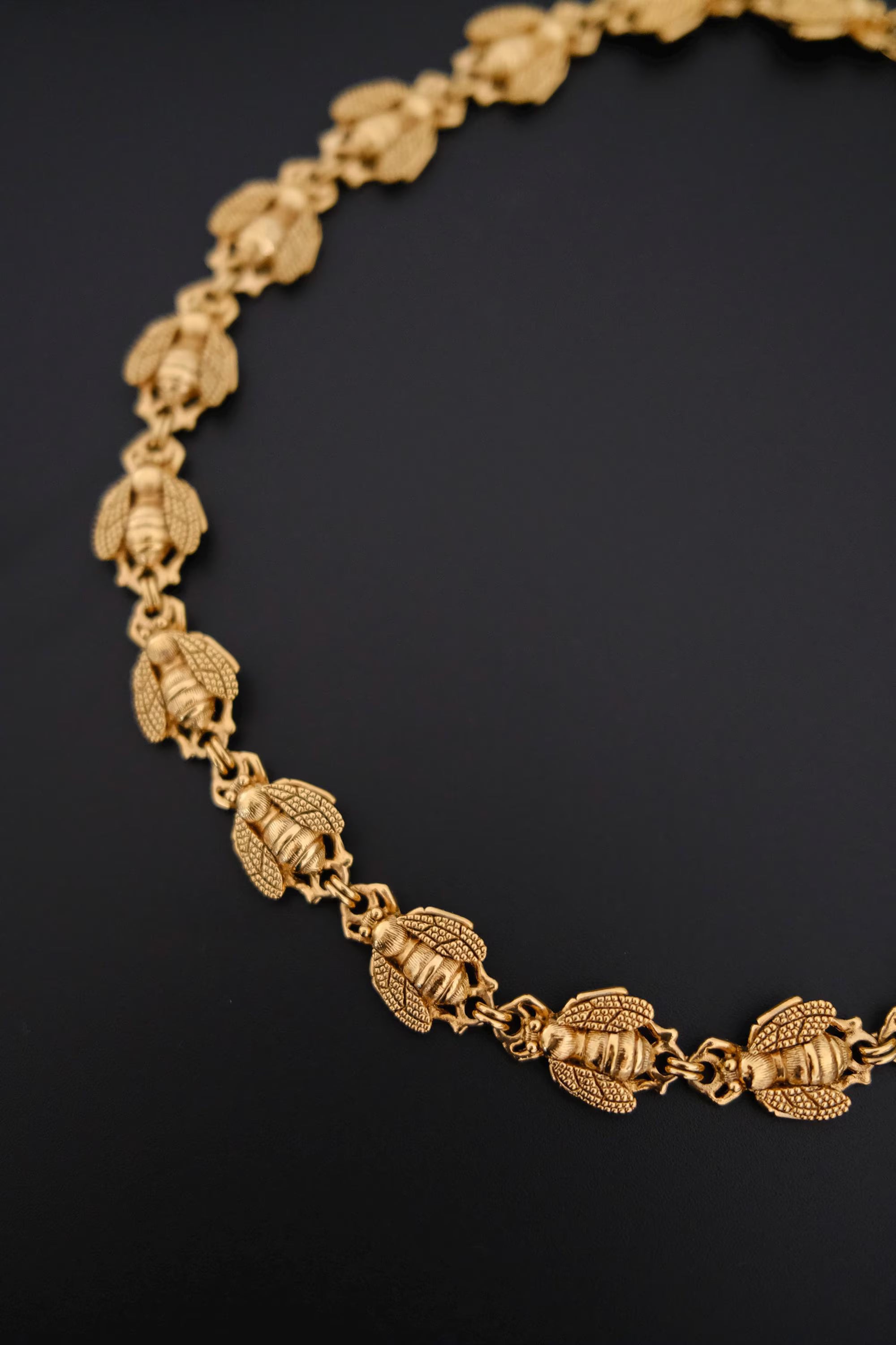 Vintage Christian Dior gold-tone necklace featuring 19 sculptural bee motifs, signed Dior Germany
