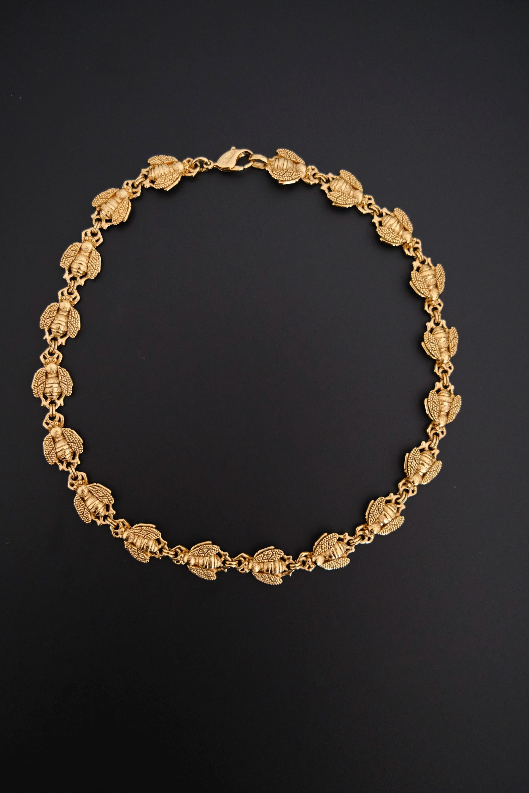 Vintage Christian Dior gold-tone necklace featuring 19 sculptural bee motifs, signed Dior Germany