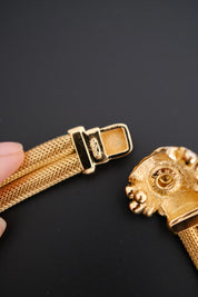 A close-up of Vintage Christian Dior gold-tone collar choker necklace with crystal-set domed front clasp