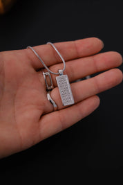 Two-sided reversible Christian Dior pendant showing textured monogram and clear crystal designs