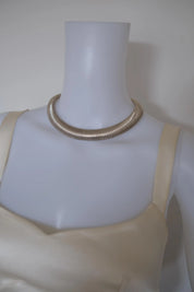 Vintage Christian Dior silver-tone Tubogas choker necklace styled with an elegant evening dress