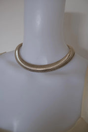 Vintage Christian Dior silver-tone Tubogas choker necklace styled with an elegant evening dress