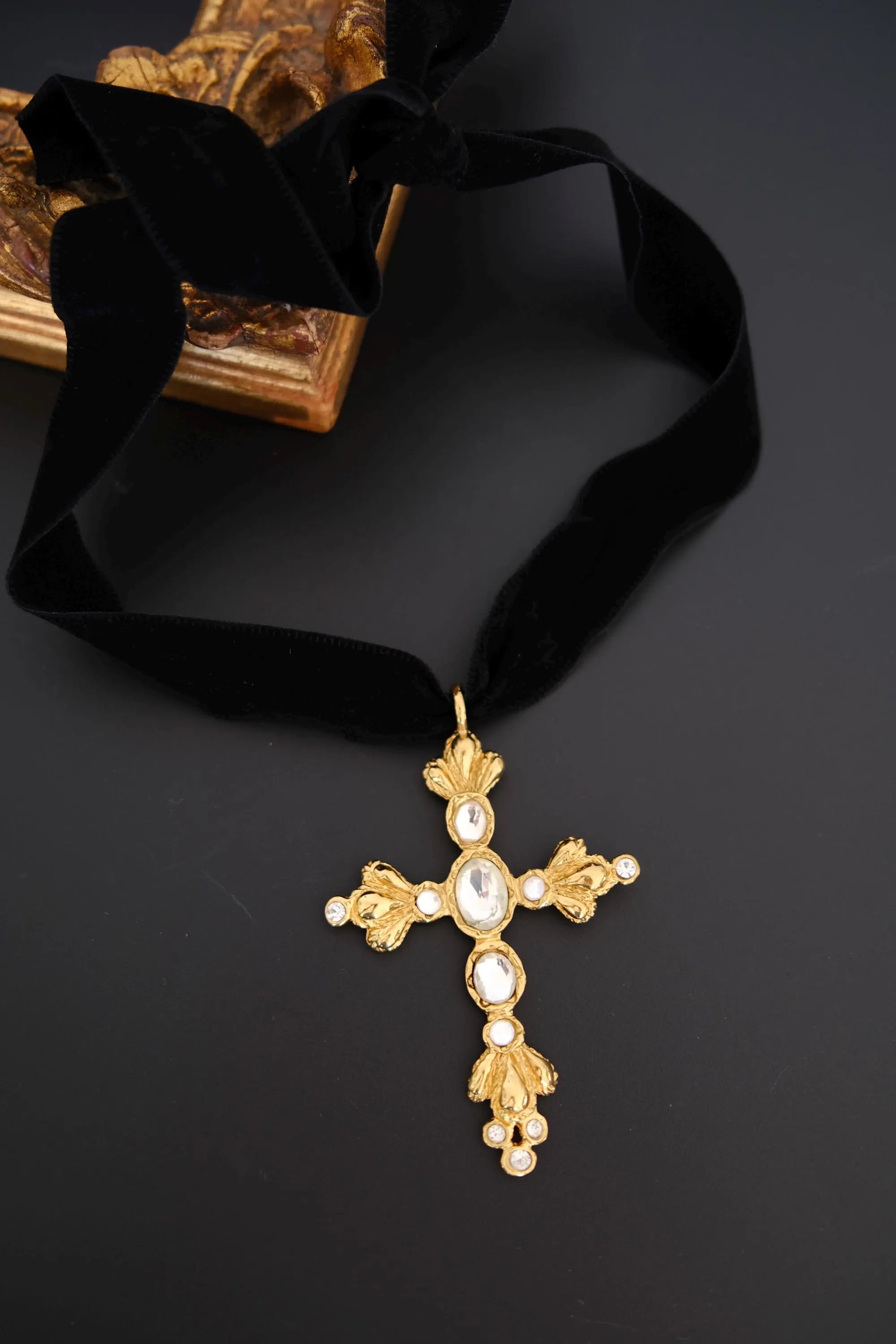 Close-up of the black velvet ribbon on vintage Christian Lacroix oversized crystal cross choker necklace
