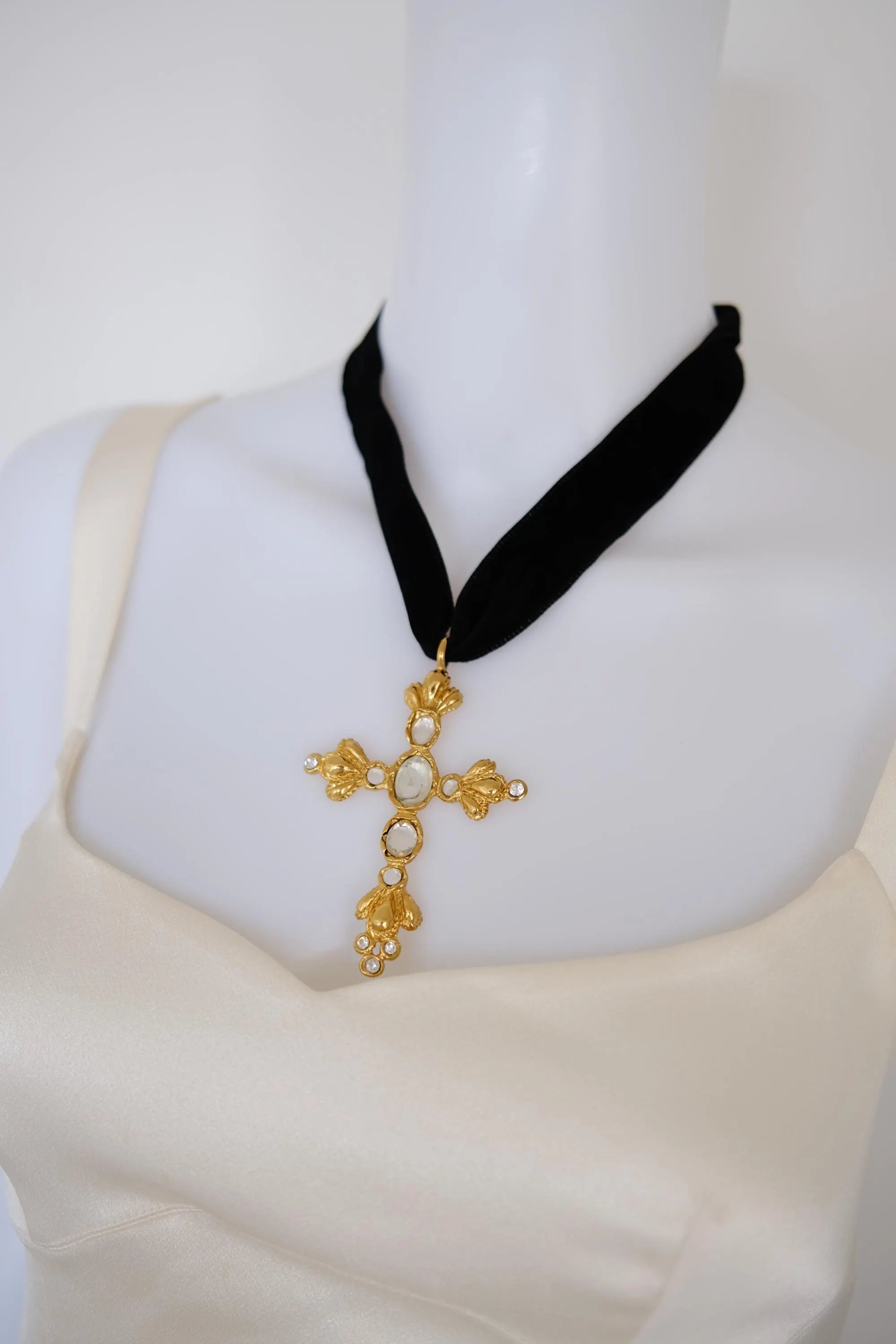 Vintage Christian Lacroix gold crystal cross pendant worn as a dramatic black velvet choker necklace