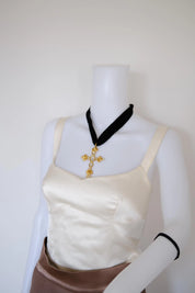 Christian Lacroix vintage oversized cross pendant styled lower on the neckline with a long black velvet ribbon