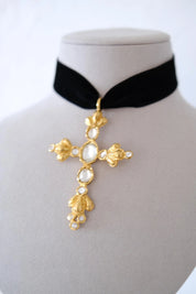 Condition close-up of vintage Christian Lacroix cross pendant showing light age-related cloudiness on some clear crystals
