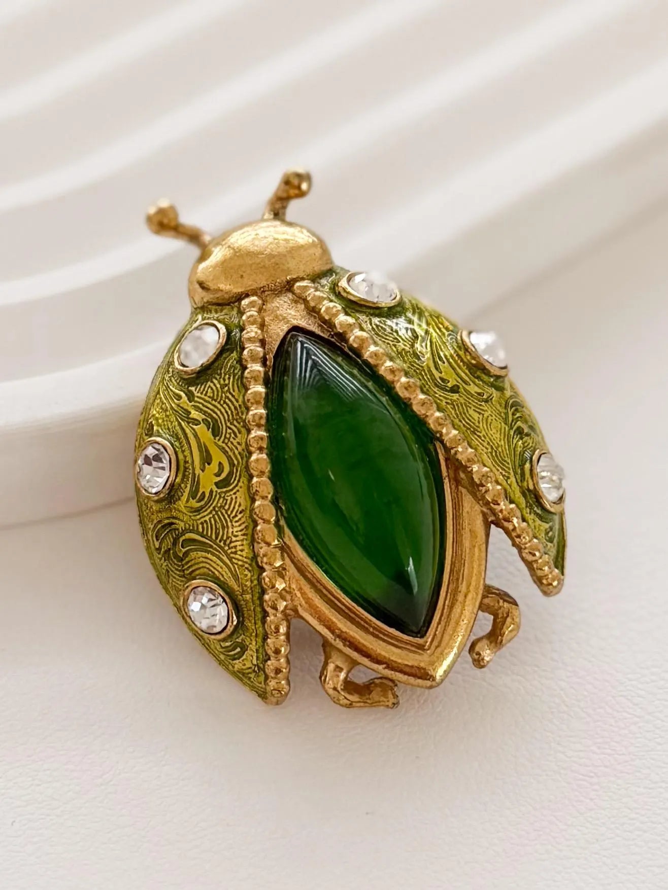 Dior beetle brooch on coat refined statement style for sophisticated women