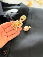 Dior gold floral brooch on coat elegant feminine style for sophisticated women