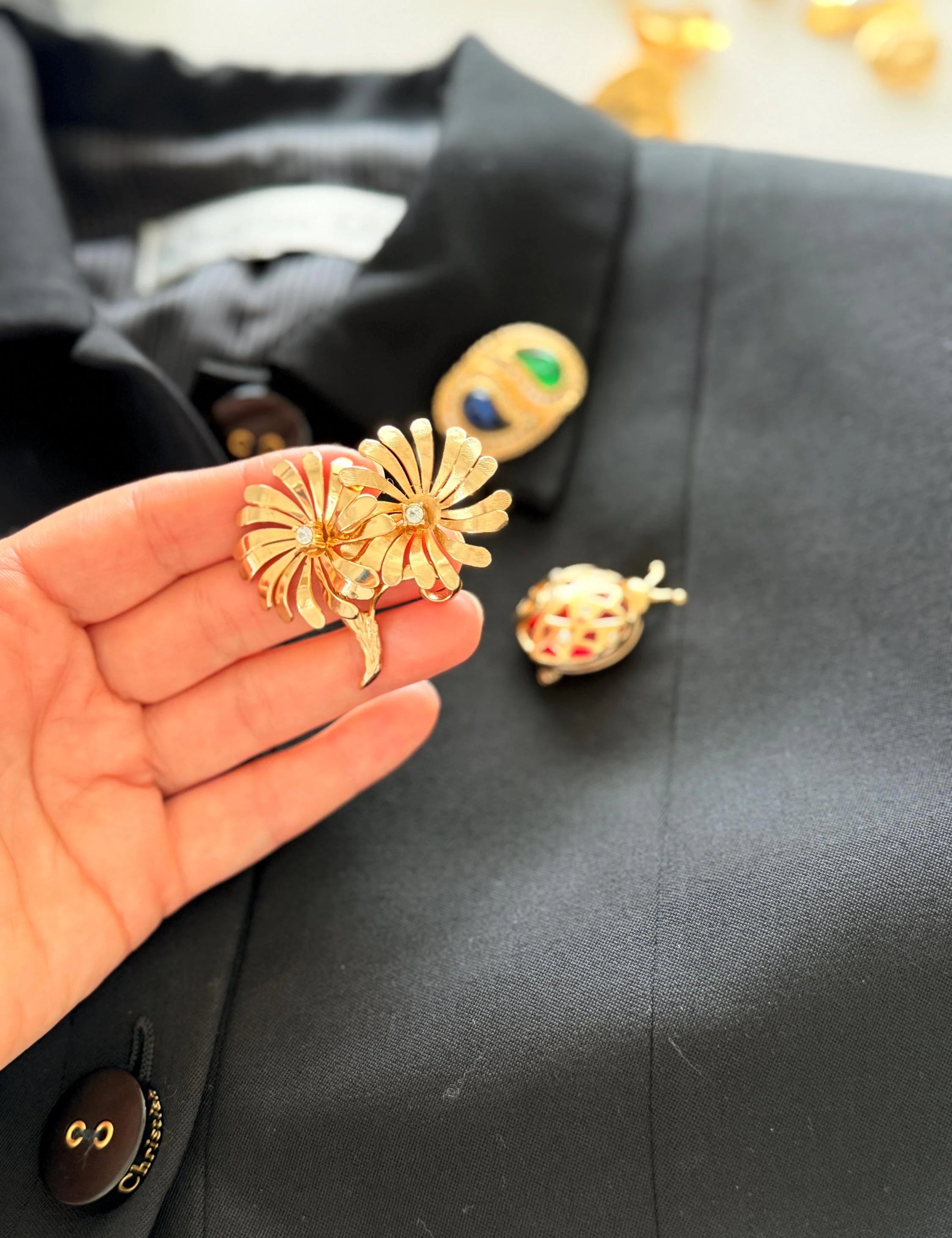 Dior gold floral brooch on coat elegant feminine style for sophisticated women