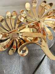 Dior gold floral brooch on coat elegant feminine style for sophisticated women