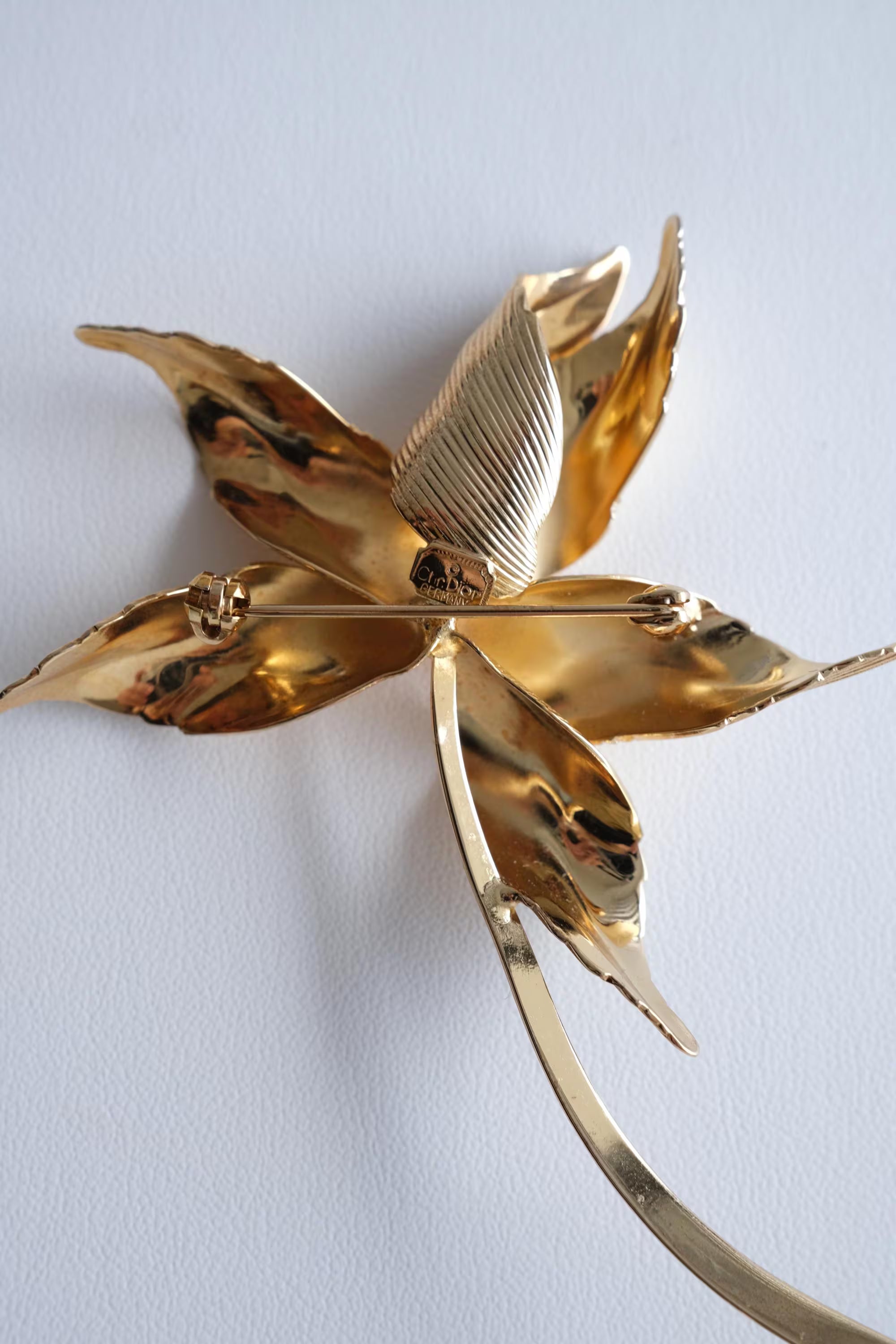 Dior large gold flower brooch on coat statement elegant sophisticated style