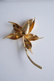 Dior large gold flower brooch on coat statement elegant sophisticated style