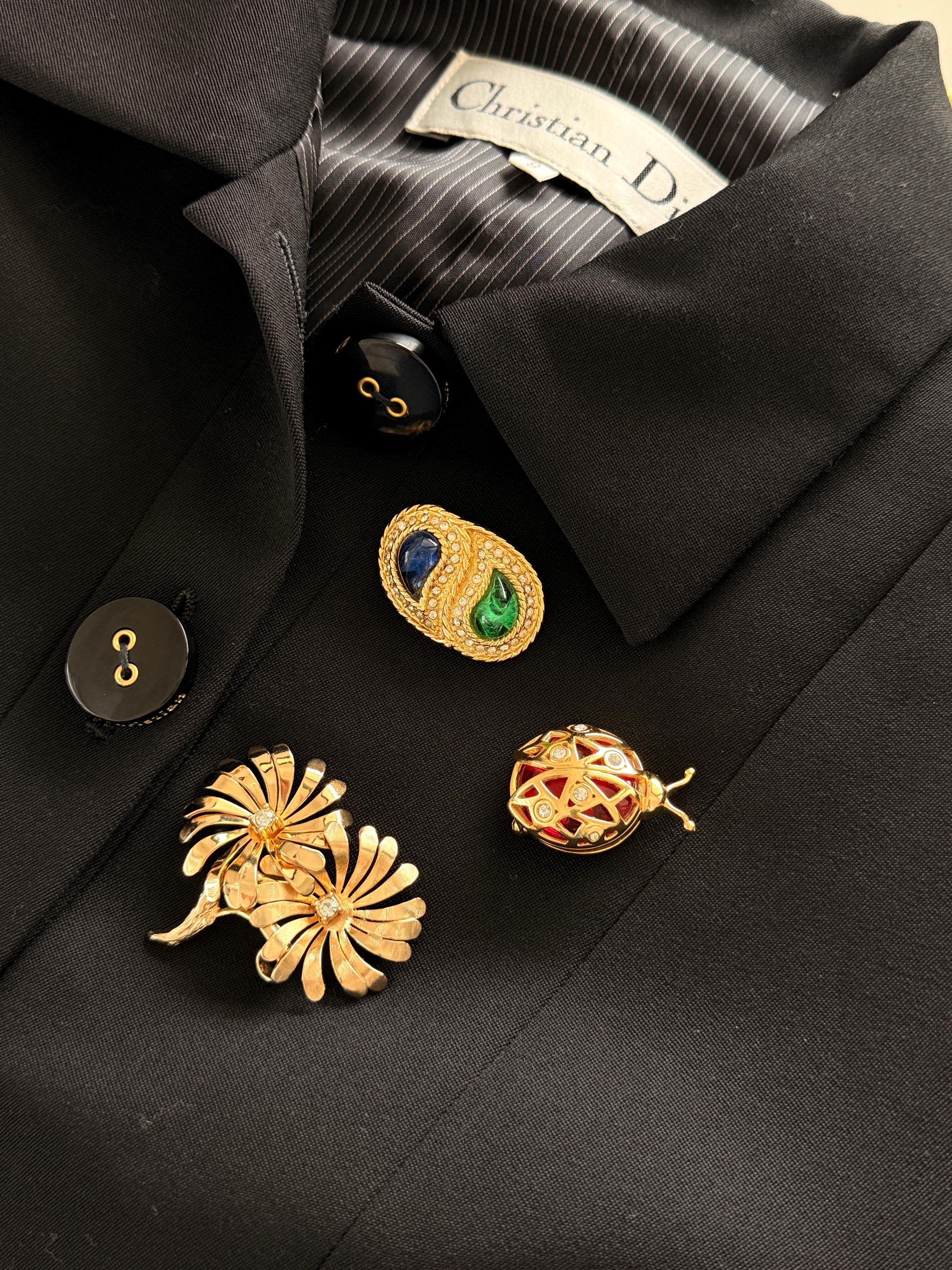 Dior gold brooch on coat with blue green cabochon timeless elegant European style