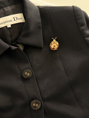 Dior ladybug brooch on coat timeless elegant European style refined look
